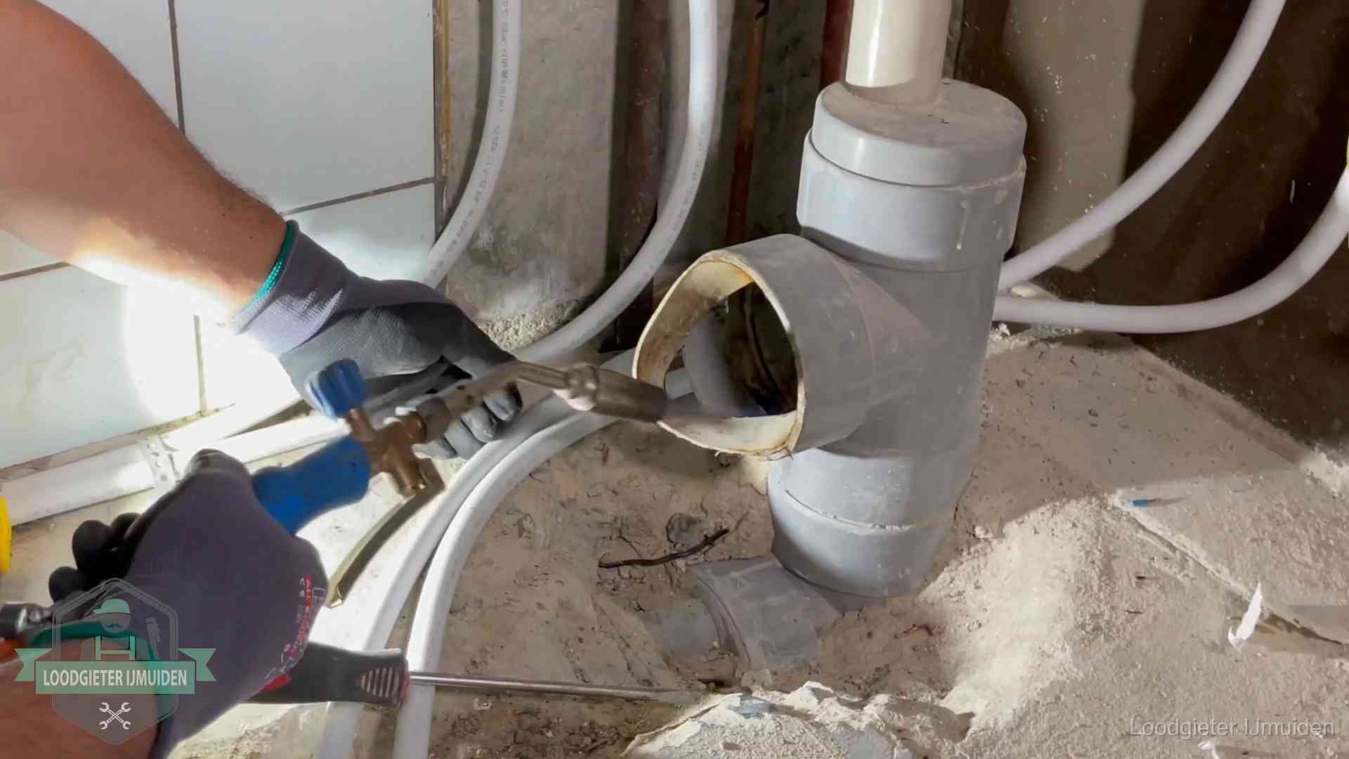 Vakmanschap van onze loodgieters in IJmuiden Loodgieter werkt met brander en messing kraanwerk aan leidingen in IJmuiden